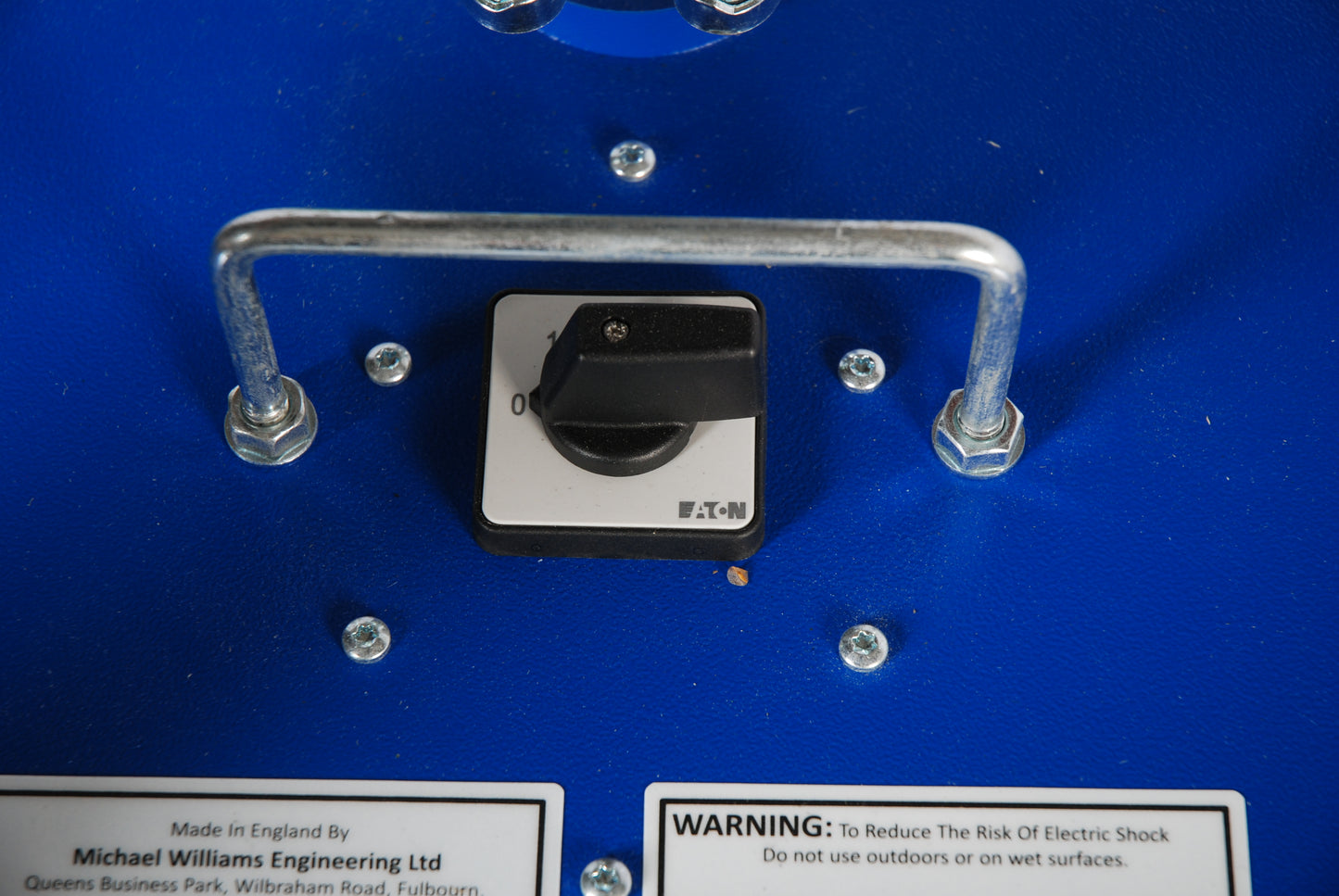 Control panel with switch and warning label on a blue background
